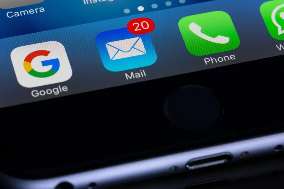 A close up of an iphone with the mail icon on it